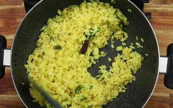 mixing rice and turmeric in lemon rice in kannada